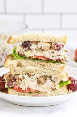 A plate with an almond chicken salad sandwich on it